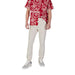Man wearing floral shirt and chinos with Tommy Hilfiger Men’s Blue Jeans Trousers