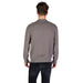 Man wearing a taupe patterned crewneck sweater and black jeans, showcasing stylish winter apparel