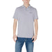 Man wearing Armani Exchange men’s blue polo shirt and blue jeans