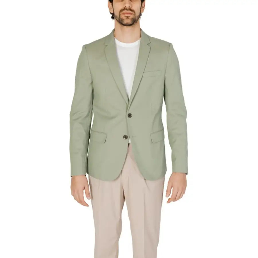 
                      
                        Antony Morato men blazer featuring a man in a green jacket and tan pants.
                      
                    