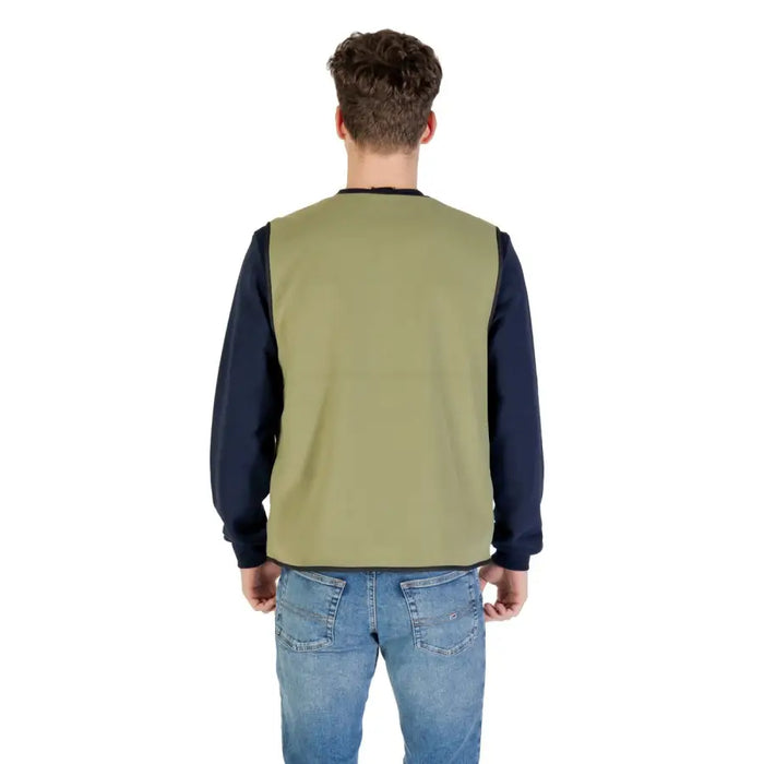 Man wearing a green vest and blue jeans, showcasing Olive Green Vest for Men