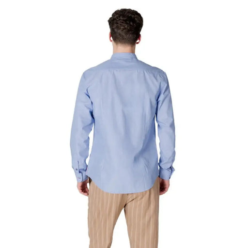 Man in light blue Gianni Lupo shirt with mandarin collar and striped pants