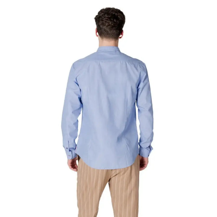 Man in light blue Gianni Lupo shirt with mandarin collar and striped pants