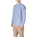Man in light blue button-down shirt and striped pants showcasing Gianni Lupo shirt