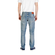 Man wearing light blue jeans and blue sneakers demonstrating style and comfort