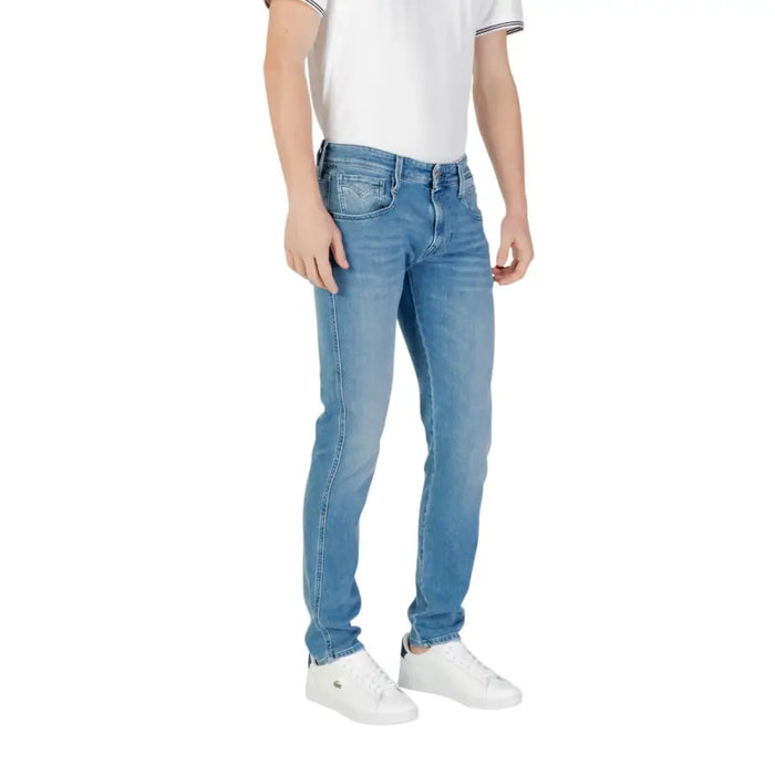 Man wearing light blue denim jeans and white sneakers showcasing casual fashion style