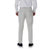 Man wearing light gray pants and dark blue sneakers in Men White Shirt and Gray Pants Apparel