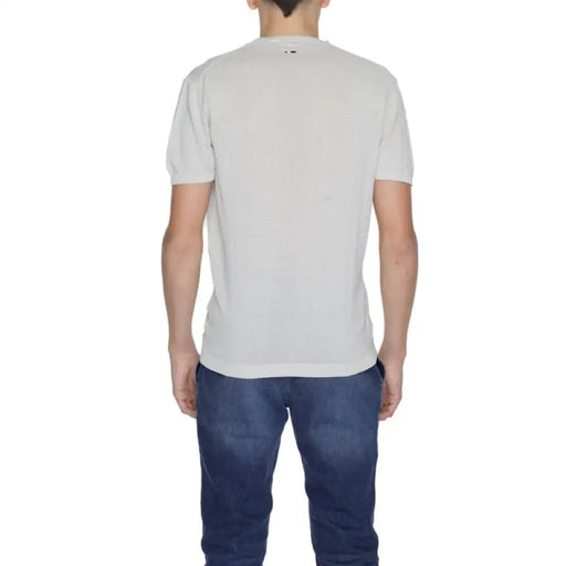 Man wearing a light gray t-shirt and dark blue jeans in Men’s Light Gray Shirts and Blue Jeans display