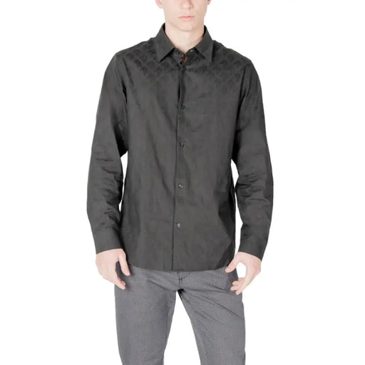 Man wearing dark wrinkled long-sleeved button-down shirt suitable for casual or formal wear