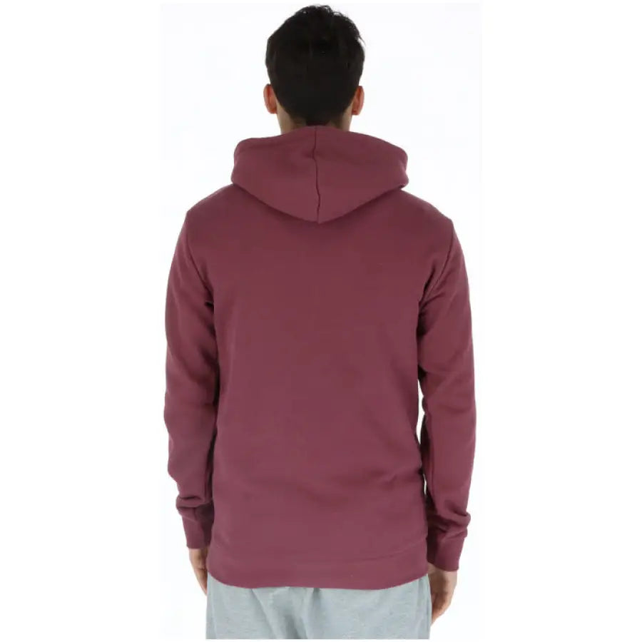 
                      
                        Man in maroon Adidas hoodie showcasing urban city style fashion
                      
                    