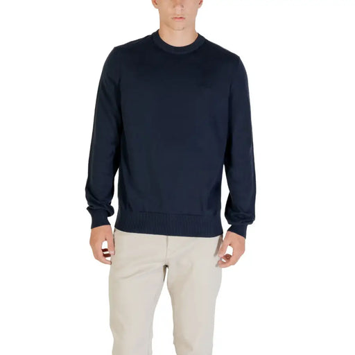 Man wearing a navy blue sweater and khaki pants for a stylish casual look