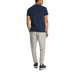 Man wearing a navy T-shirt and gray pants showcasing casual men’s fashion