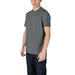 Man modeling Armani Exchange Black Geometric Mens T Shirt with a patterned gray design