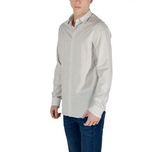 Man in patterned long-sleeved shirt wearing Armani Exchange Men’s Beige Geometric T-Shirt