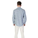 Man in a Replay Men’s Light Blue Floral Shirt with patterned long sleeves and light pants