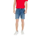 Man wearing a red T-shirt and denim shorts with white sneakers for casual style