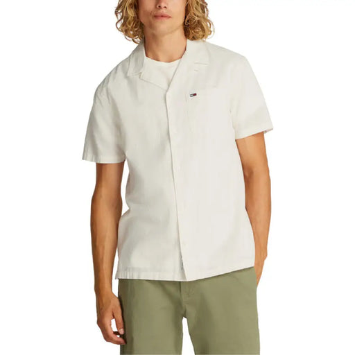 Male model wearing a short-sleeved off-white shirt and green pants for Mens Casual Summer Outfit