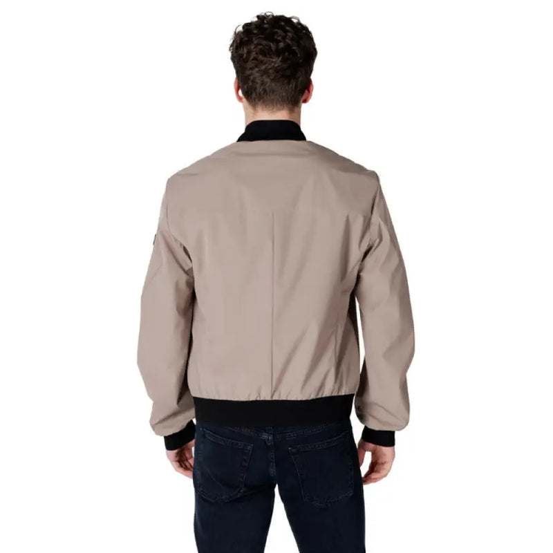 Man showcasing a stylish Beige Bomber Jacket in tan color
