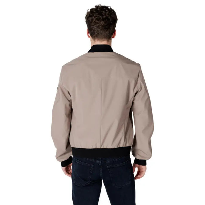 Man showcasing a stylish Beige Bomber Jacket in tan color