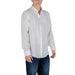 Man in white button-down shirt and blue jeans showcasing Armani Exchange Men’s White Linen Shirt