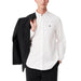 Man wearing a white button-down shirt and black blazer from Men Casual Beige Outfit with Blue Shirts and White Tote Bag
