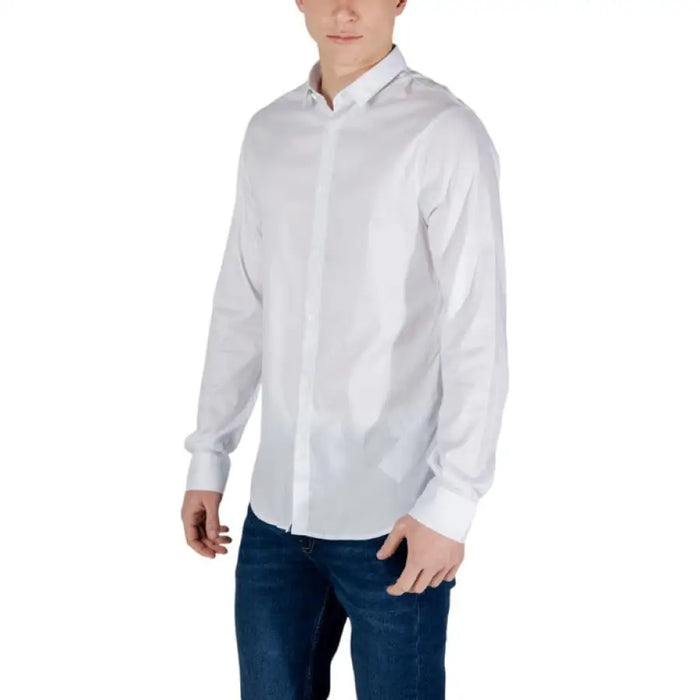 Man in white long-sleeved shirt and blue jeans wearing Armani Exchange mens shirt