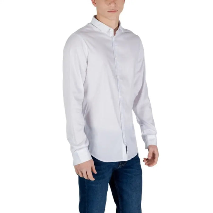 Man wearing Armani Exchange Mens Long White Button Shirt with blue jeans