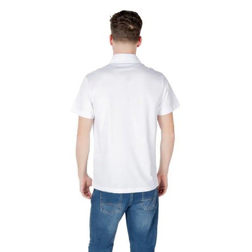 Man wearing a white polo shirt and blue jeans in product imagery