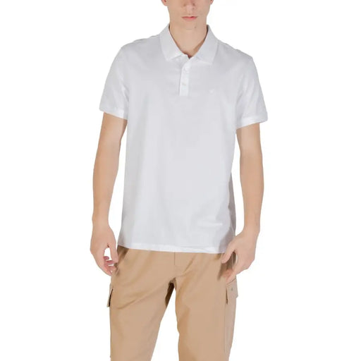 Man wearing a white polo shirt and khaki cargo pants on a model display