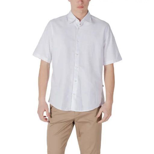 Man wearing a white short-sleeved shirt and khaki pants for the Mens White Short-Sleeved Shirt and Khaki Pants product display
