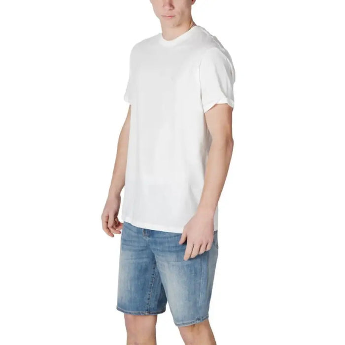 Man in white cotton t-shirt and blue denim shorts by Armani Exchange