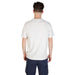 Man wearing a white crewneck T shirt with blue cargo pants for a stylish look