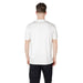 Man wearing a white T shirt with logo and black pants for Mens White T Shirt with Logo product