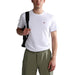 Man in white Napapijri cotton T-shirt and green cargo pants showcasing casual style