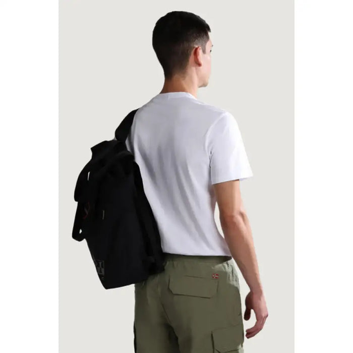 Man in white Napapijri cotton t-shirt and green cargo pants with black backpack