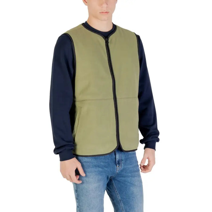 Man wearing an olive green vest for men, showcasing stylish men’s outerwear