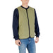 Man wearing an olive green vest for men, showcasing stylish men’s outerwear