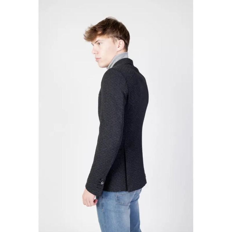 Man in a patterned black blazer from the Mulish Men Fall Winter collection