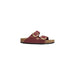 Maroon sandals with gold buckles from Birkenstock Women’s Leather Slippers in Brown