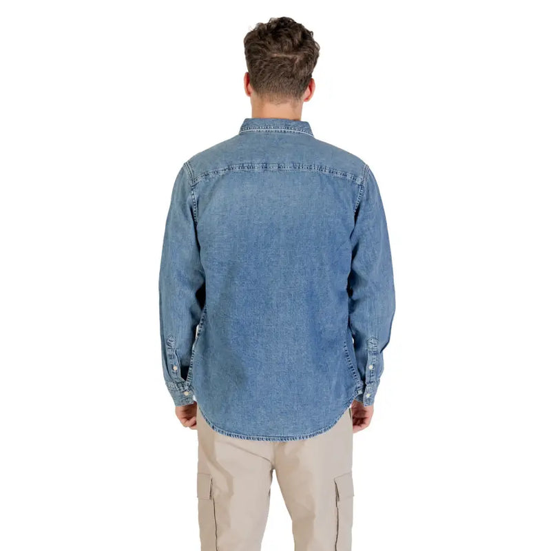 Men blue denim long sleeved shirt made of medium wash denim with classic collar and stitched detailing