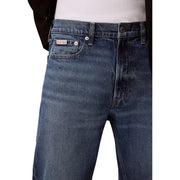 Men’s blue denim jeans with classic five-pocket design and calvin klein label visible on the back pocket