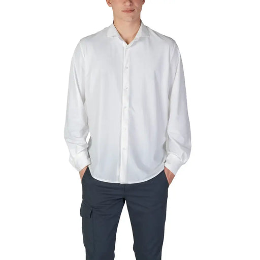 Mens long white plain button shirt paired with dark cargo pants for fall winter fashion