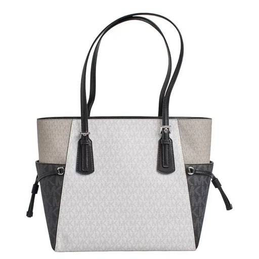 Michael Kors black slip on handbag tote with light gray and black two tone panels and signature monogram pattern