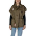 Military-style olive vest with patches over black long-sleeve top and Replay shirt