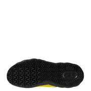 Black and yellow sneaker with textured sole, likely adidas model.