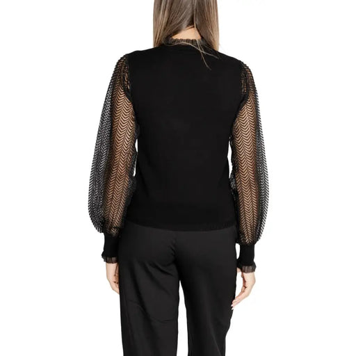 Women’s black long-sleeve turtleneck knitwear with sheer patterned sleeves by Morgan De Toi