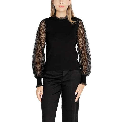 Women’s black long-sleeve turtleneck knitwear with sheer patterned puff sleeves by Morgan De Toi