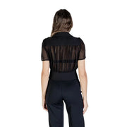 Women wearing Morgan De Toi black V neck blouse with sheer stripes and high-waisted wide-leg pants