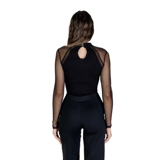 Woman wearing Morgan De Toi black viscose blend long sleeve blouse with sheer polka-dotted sleeves