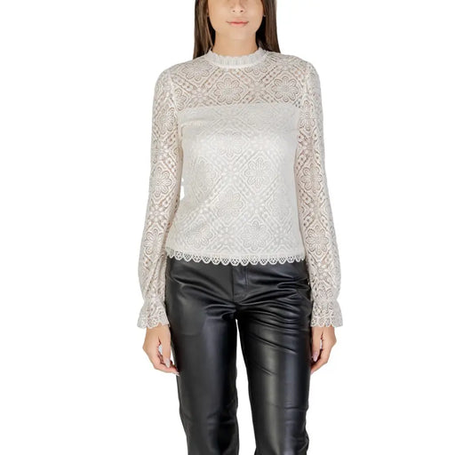 Women’s long-sleeve white lace blouse with high neck paired with black faux leather pants